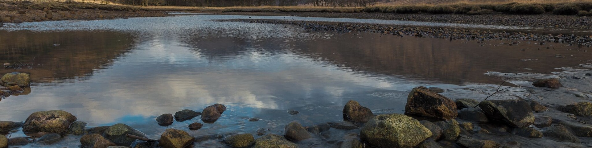 The north end of Loch Etive is dominated by the view up Glen Etive to the twin mountains of Buachaille Etive Mor and, to its west, Buachaille Etive Beag. The north ends of these twin ridges dominate the upper parts of Glen Coe, but from the south they appear as twin cones.
Loch Etive is accessible by car via a 14 mile drive down scenic Glen Etive along a minor road that starts at the head of Glen Coe.  
And binoculars should be an essential companion on a journey up Loch Etive. The seals that have hauled themselves out onto the rocks in the loch are easily visible. But it is often more difficult to spot the deer on the hillside, the golden eagles swooping over Beinn Trilleachan or the sea eagles now increasingly being seen here.
#hiddenscotland #discoverscotland #glencoe #glenetive #igscotland #ig_scotland #scotland_insta #scotland_ig #uk #perspectives #winter #walking #hiking #outdoors #swimming #outdoorswimming #loch #water #sunset #mountains #munros #nature #scotland #uk #britain #travel #landscape