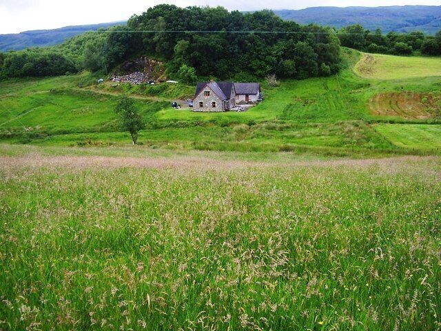 Stonefield in Argyll Looking over the long grasses on the hill towards The croft house at Stonefield.