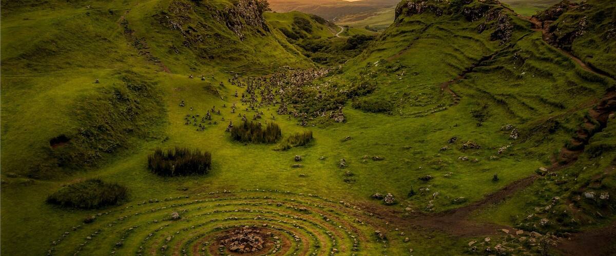 The Fairy Glen near Uig on the Isle of Skye in Scotland and its bizarre and delightful miniature landscape of grassy, cone-shaped hills, is a fascinating and otherworldly place to visit on a sunny day. This place can get jam-packed during the day, but its very quiet at the end of the day just before the sun set behind the horizon with the opportunity to capture a photo like this.