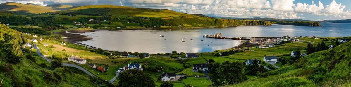 A coastal village with houses, a pier, and a bay.