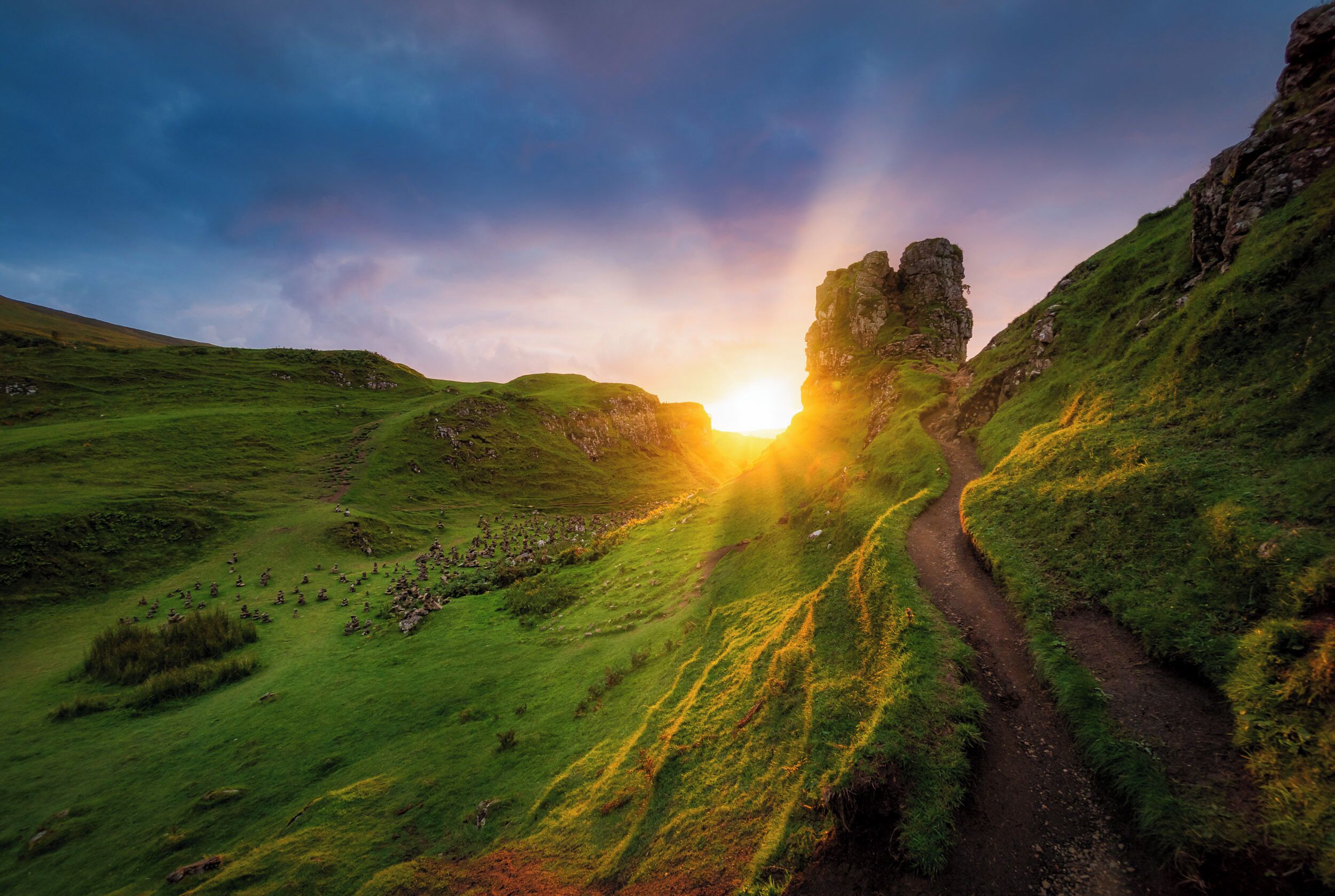 On the West side of Trotternish at Balnacnoc - above Uig, is the Fairy Glen – a Quirang-like landslip in miniature. The road winds around small round-topped grassy hills with lochans (ponds) in between which gives the glen an otherworldly feel.