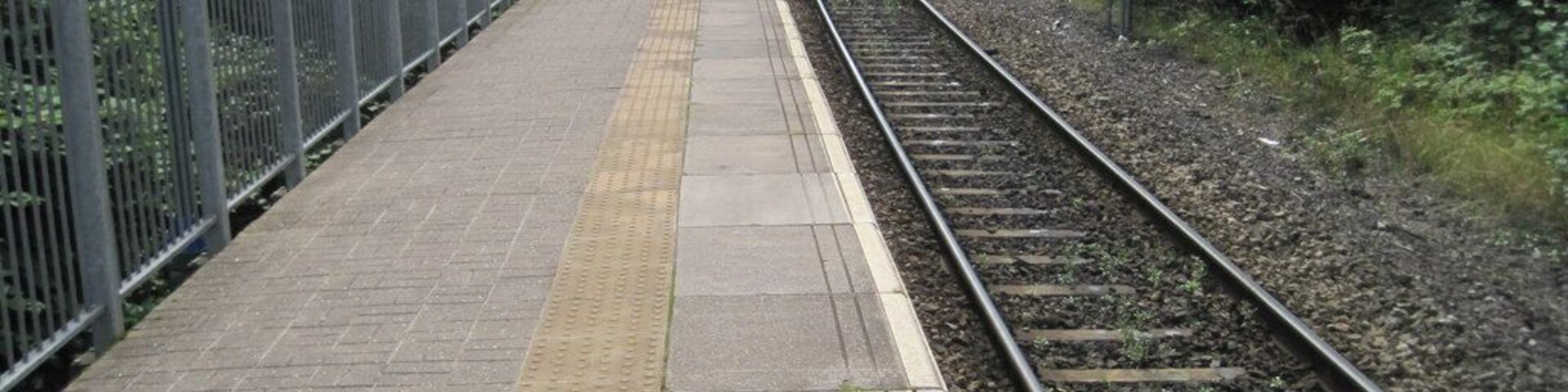 Cwmbach railway station, Mid Glamorgan. Opened by the Great Western Railway in 1914 on its Vale of Neath line from Swansea Victoria to Pontypool Road via Aberdare (High Level) and Quakers Yard, this station closed in 1964. It was rebuilt and reopened in 1988 but instead of going straight on to Quakers Yard, this view south east shows it now curving sharply to the right to join the ex Taff Vale Railway line southwards to Abercynon (which had originated in Aberdare Low Level, now gone).