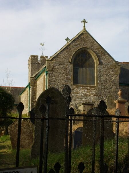 A stone church with a pointed roof and arched windows.