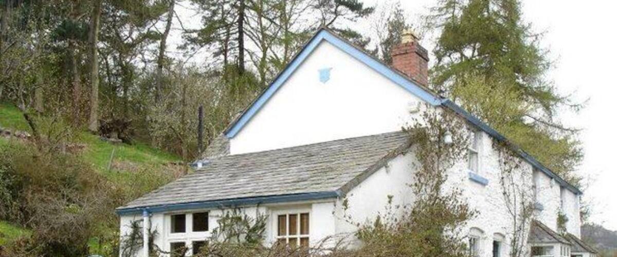 Stone cottage at Pont Yr Aled. A whitewashed stone cottage near to the bridge.