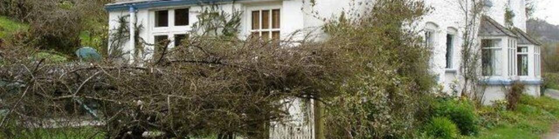 Stone cottage at Pont Yr Aled. A whitewashed stone cottage near to the bridge.