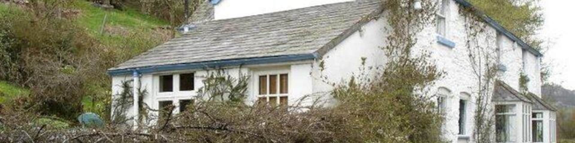 Stone cottage at Pont Yr Aled. A whitewashed stone cottage near to the bridge.