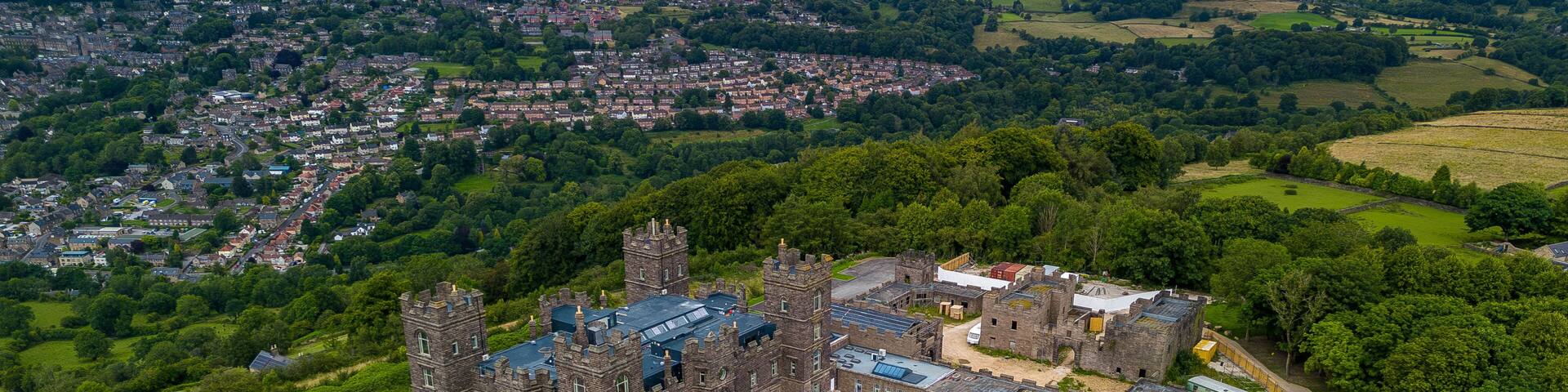 Aerial View of I'm a Celebrity's Gwrych Castle and Gardens Undergoing Restoration with Urban Landscape Beyonu