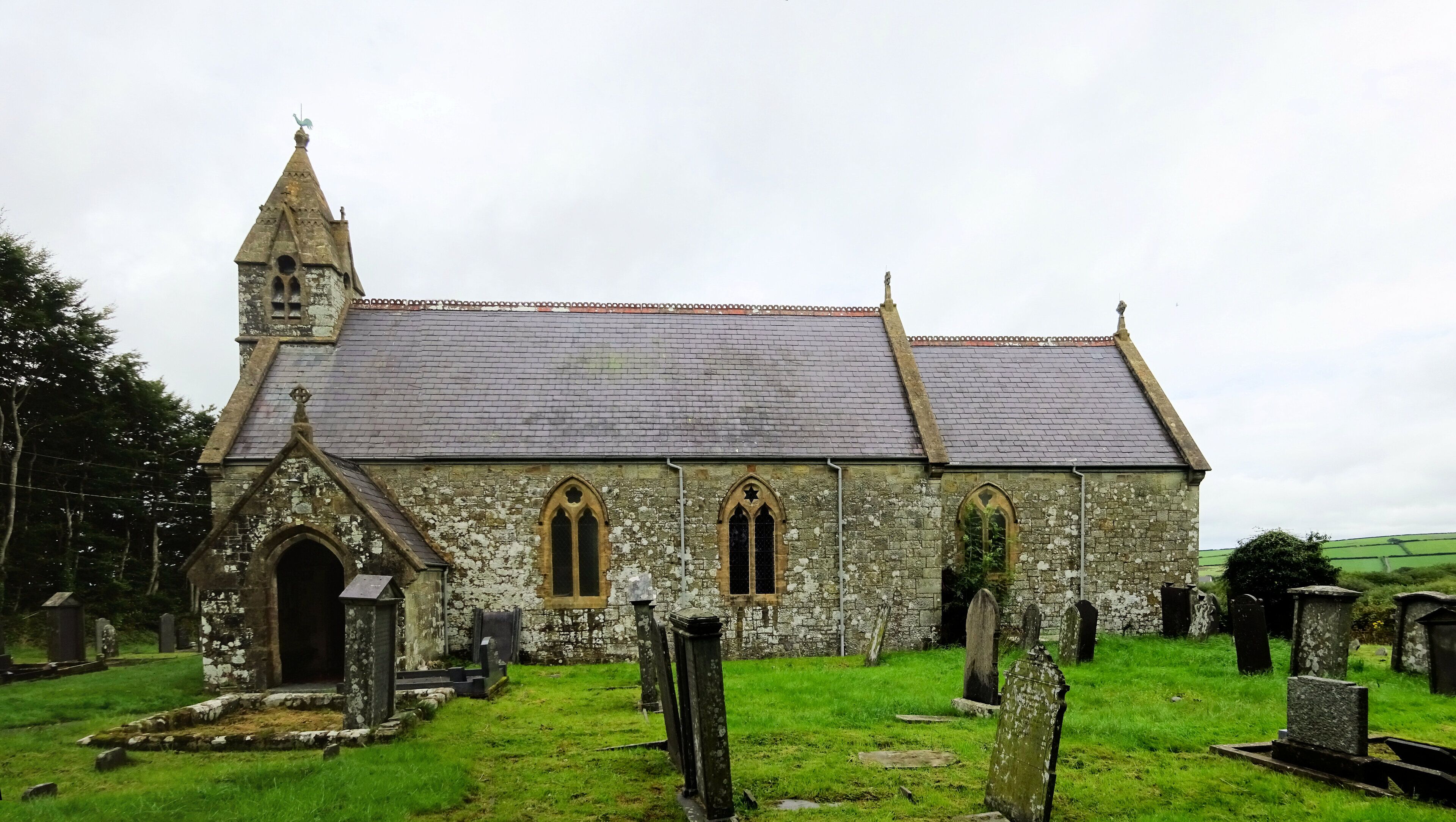 A historic church with a pointed steeple and arched windows.