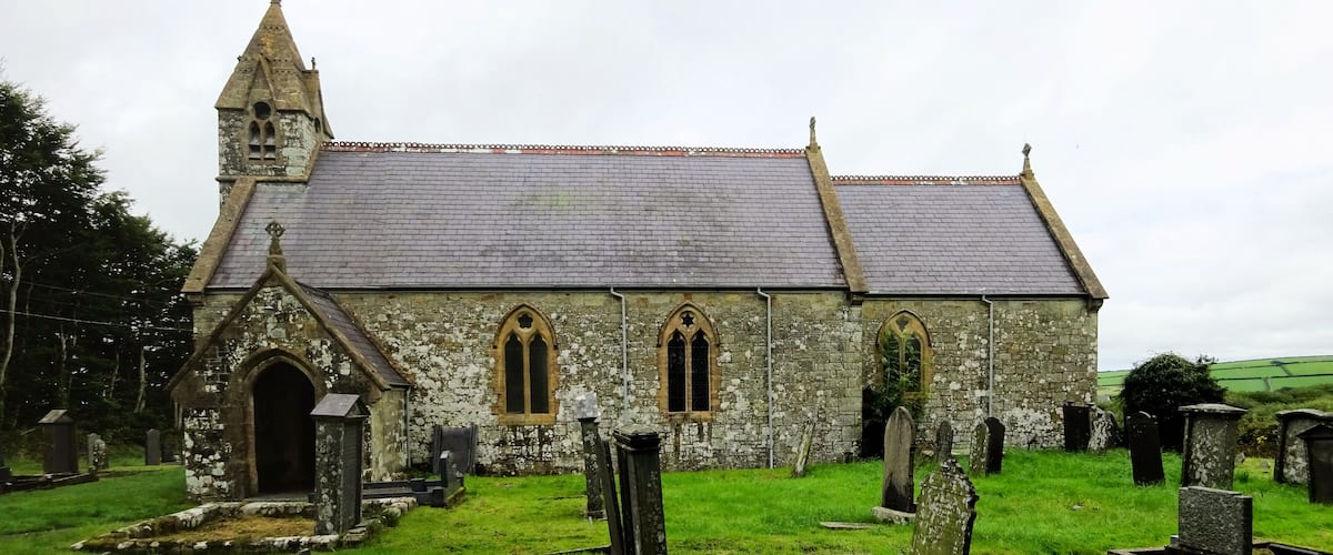 A historic church with a pointed steeple and arched windows.