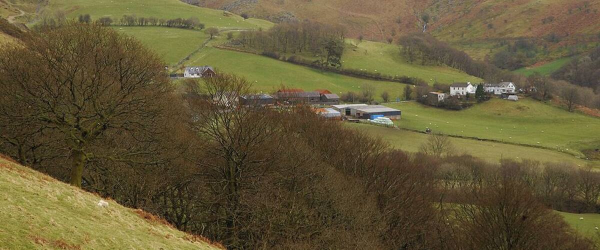 Cwmystwyth seen from the west Cwmystwyth is a fairly scattered community, the farm and nearby houses are about as dense as it gets, although there is another small group of houses just down the road from where the photograph was taken.