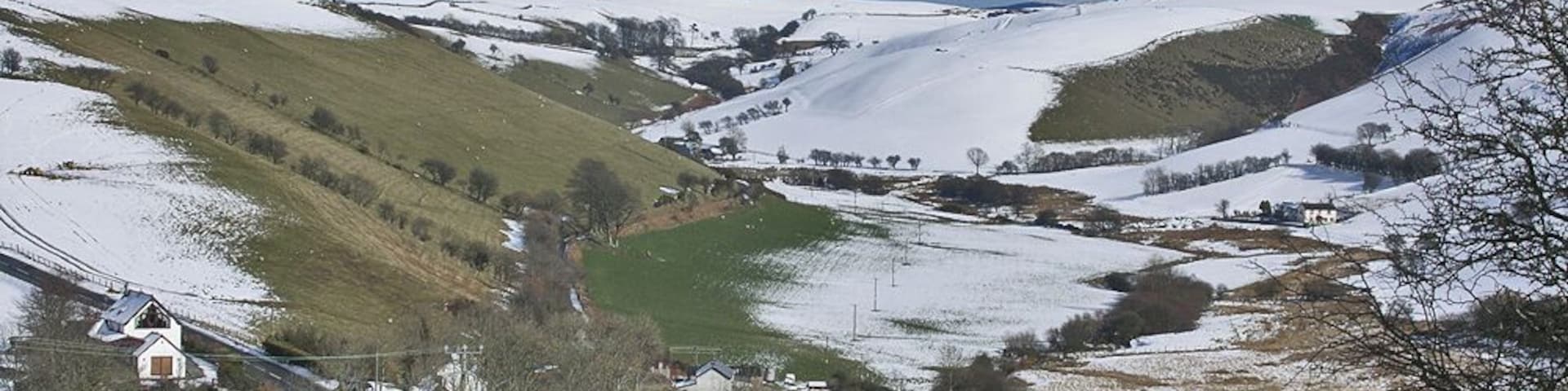 East end of Pisgah The east end of this well spaced community lies in a dip, actually a col between the Rheidol and Gledryd valleys; the latter can be seen ahead. An ancient road to the east, now a bridleway, climbs along the valley side to the right, another old route proceeds up the valley, but today the main road, seen bottom left, sweeps left to contour high above the Rheidol valley.