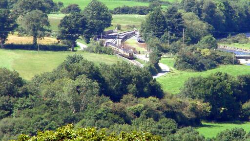 A Vale of Rheidol Railway train enters Capel Bangor station, Data from Geograph: Description: An up train (to Aberystwyth) enters Capel Bangor station, viewed from the top of the Pant Da Nature Reserve, about 1 mile away. The Vale of Rheidol Light Railway https://www.geograph.org.uk/gallery/the_vale_of_rheidol_light_railway_6996 ICBM: 52.399460433796, -3.9888929307688 Location: (about 1 km from) near to Capel Bangor, Ceredigion/Sir Ceredigion, Great Britain.