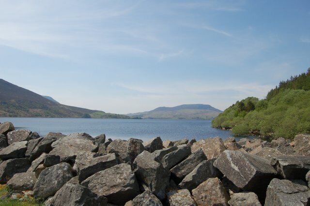 A lake surrounded by rocky terrain and hills.