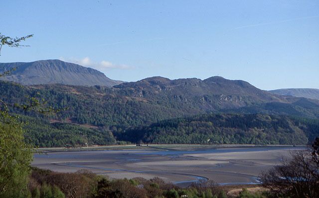 The Mawddach estuary from Bontddu Taken from the minor road up Hirgwm. On the skyline on the left are the cliffs of Craig-las. The line of the old railway between Dolgellau and Morfa Mawddach can be clearly seen on the other side of the estuary.