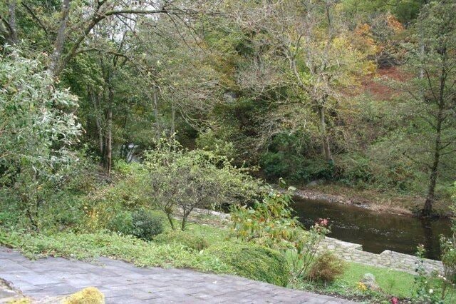 Edw past the garden The river Edw passing the garden of a house on the bank.