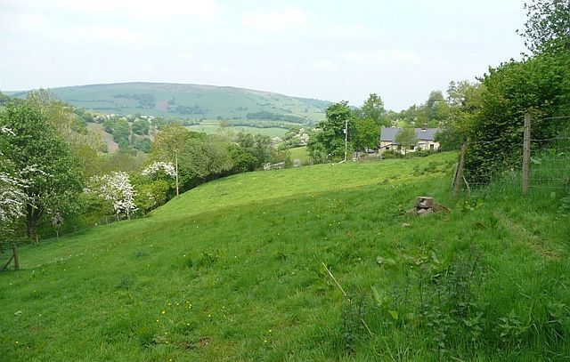 Neuadd Fadog The footpaths and bridleways in this area are confusing and seem to be in dispute. Having walked through the farmyard following the bridleway clearly marked on the map, I had a long conversation with the owner about them, accompanied by the noise of dogs, turkeys and sheep. Looking north with Moelfre behind.