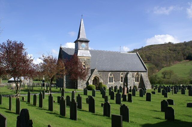 A church with a steeple and a graveyard.