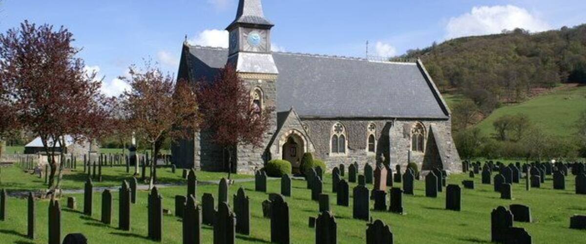 A church with a steeple and a graveyard.