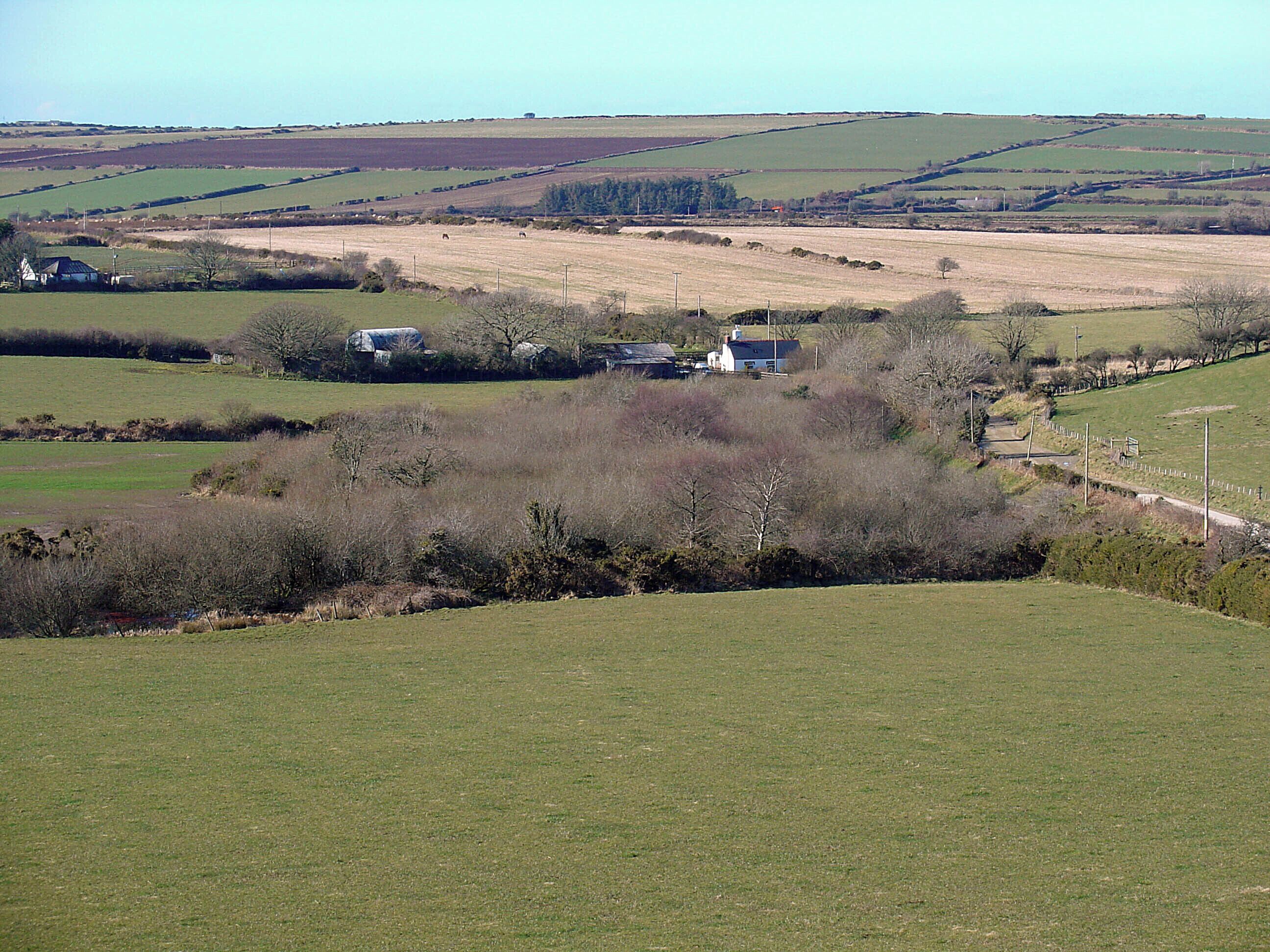View WNW from Crugiau Cemaes The farm in the middle distance is Trecernydd.