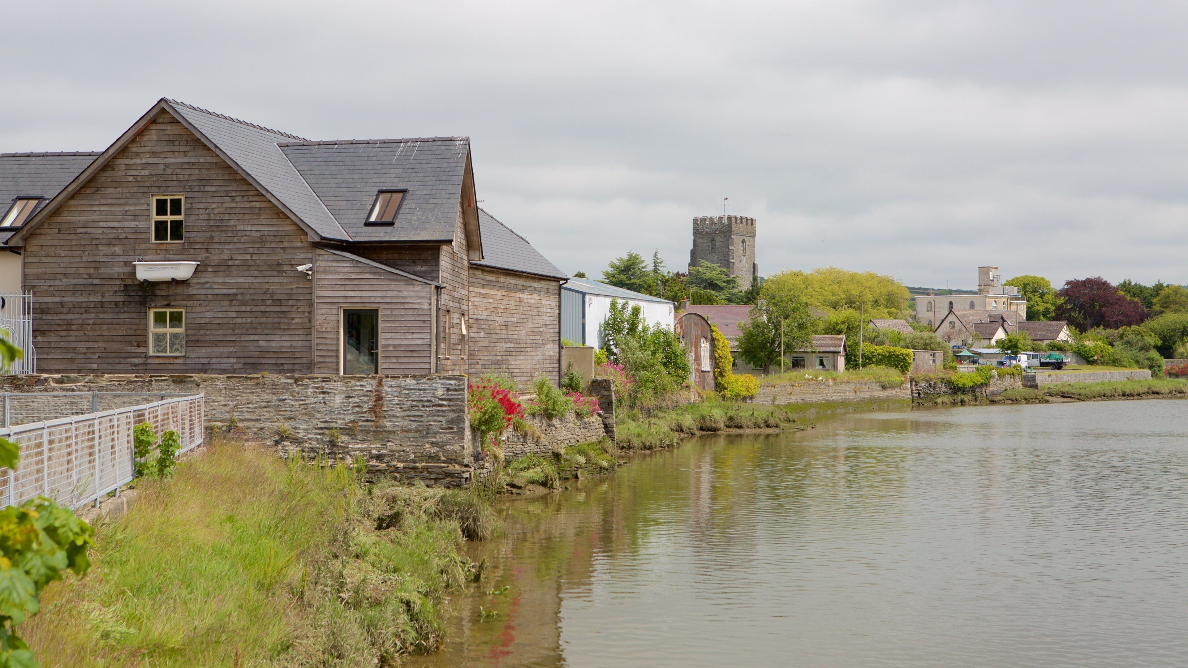Cardigan showing a small town or village and a river or creek