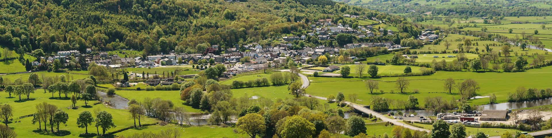 Panoramic aeriial landscape view of farms and hills above the town of Corwen North Wales