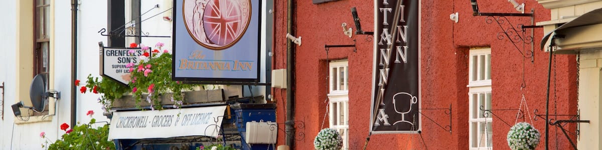 Ein rotes Gebäude mit einem Schild für 'Britannia Inn' und einem Schild für 'Grenfell's Sons'.