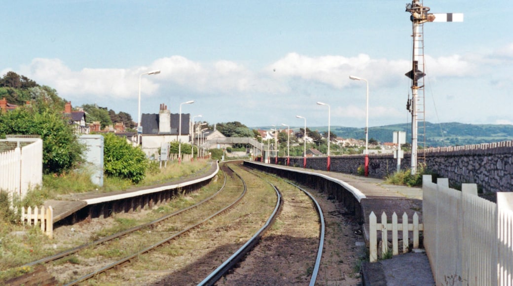 Deganwy station, 1992. View SE, towards Llandudno Junction: ex-LNWR Llandudno branch. This is the one intermediate station on this short branch; it has remained open - but look at the weeds! (Cf. SH7779 : Deganwy Station). The Conwy Estuary is ahead and in the distance is Mynydd Llanelian (1,036 ft.) and other hills of the Conwy County east of the Vale of Conwy.