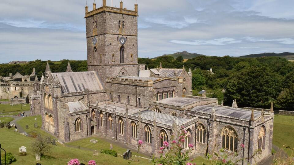 A historic church with a prominent tower and arched windows.