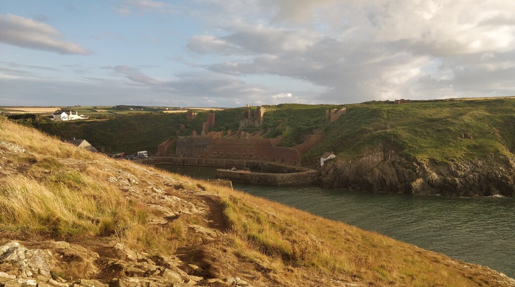 Porthgain harbour showing remains of industrial stone, slate and brick works and the hoppers used to store crushed stone before shipment.