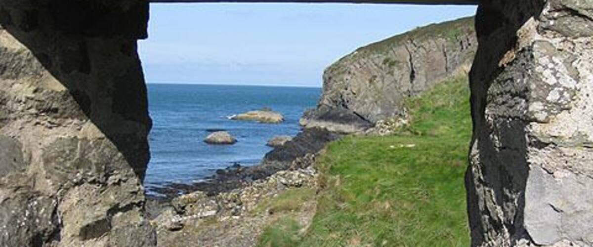 Through the rectangular window. A view of the rocky coastline at Aber Draw through the window of the ruined watermill. See also 1518296
