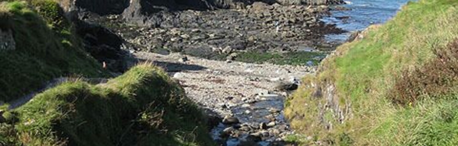 Stream reaches the sea, Aber Draw. Water from the stream would have been diverted via a leat to the nearby Trefin Mill in the days when it was used for grinding wheat and barley. See also 1518296 Viewed from the footbridge over the valley on the coast path. Note the 'stone circle' top left. 1519624
