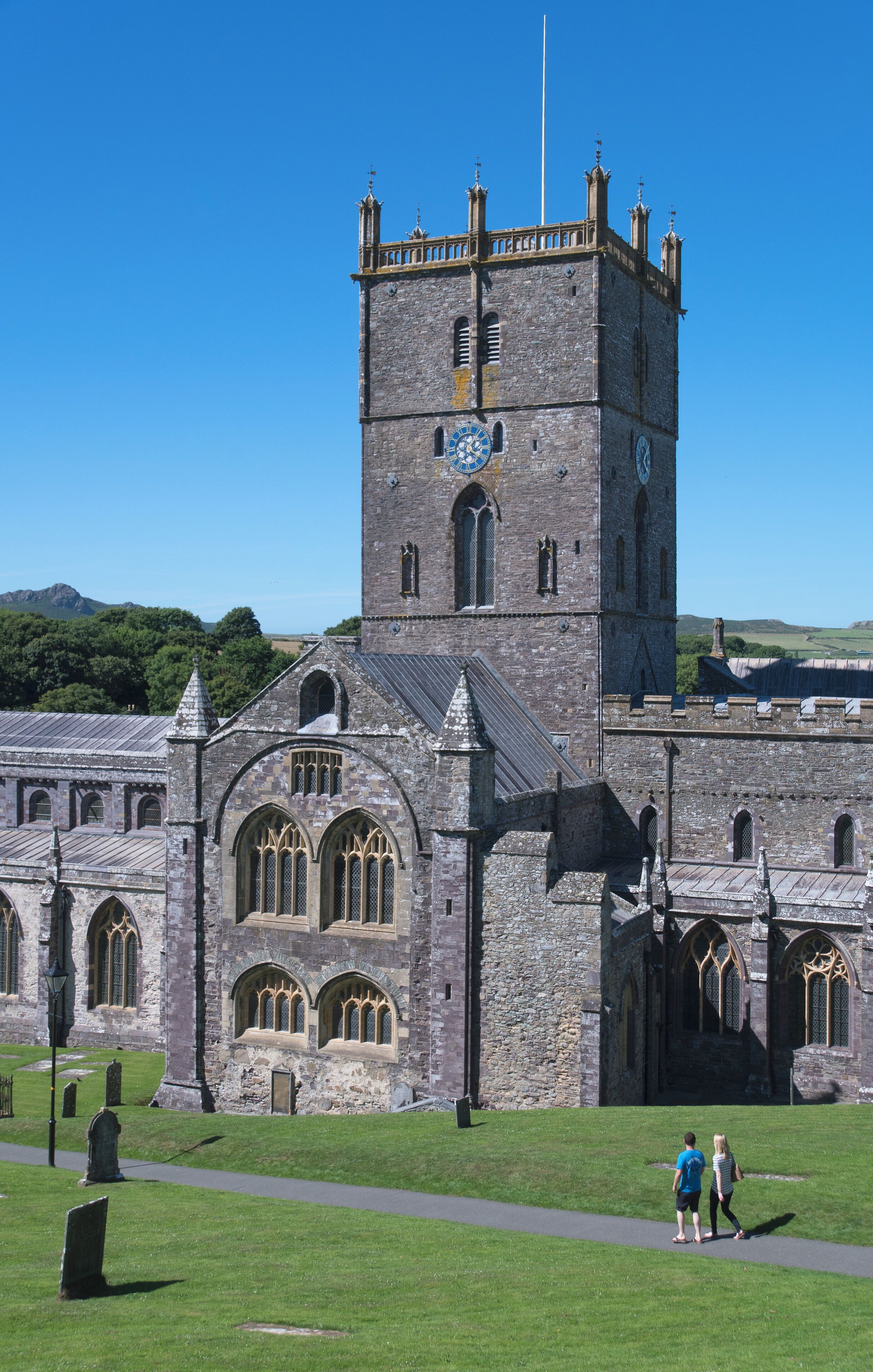 A historic stone church with a tall tower and arched windows.