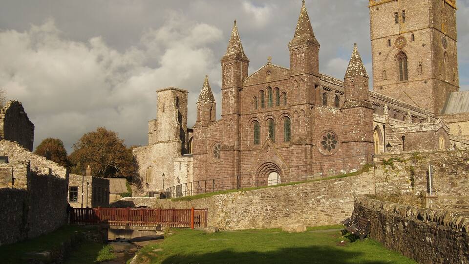 A historic stone castle with multiple towers and a moat.