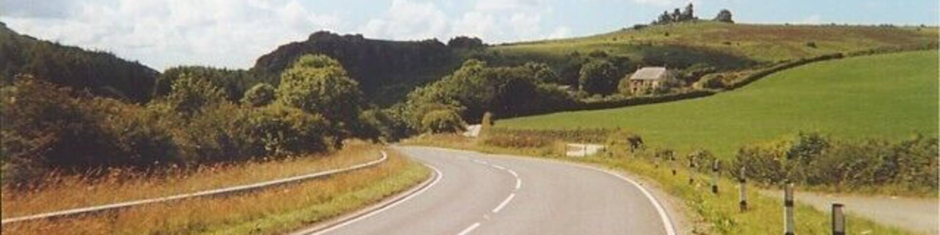 The approach to Treffgarne Gorge. Near Treffgarne, the birthplace of Welsh hero Owain Glyndwr, south of Wolf's Castle, the western branch of the River Cleddau cuts its way through a narrow gorge which it shares with both the A40 road and the railway from Fishguard. Above them all are the ruins of Maiden Castle.