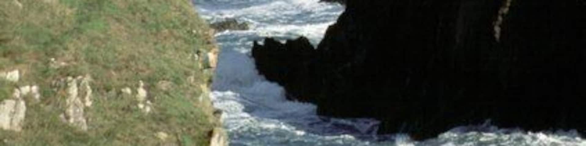 Abercastle, looking towards Pwllcrochan Looking through the channel between Ynys y Castell and the harbour inlet at Abercastle past the headland of Trwyn Llwynog to the remote beach at Pwllcrochan below St Nicholas. This shows the rugged nature of the Pembrokeshire coast in this area.