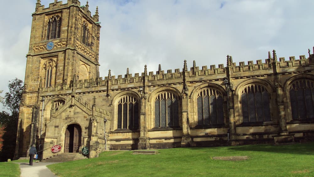 A historic church with a tall tower and arched windows.