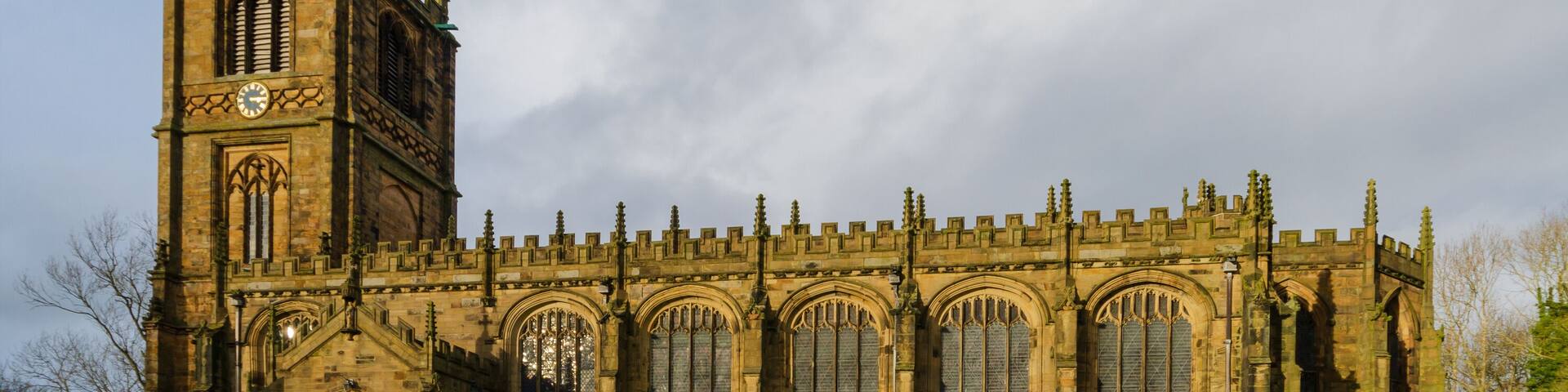 A historic church with a tall tower and arched windows.