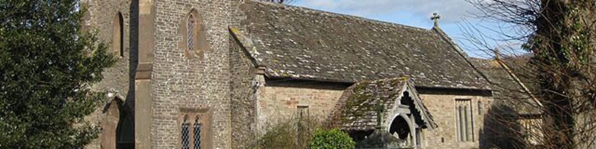 View to the Northeast of St. Dingat's Church The church is in the Early English and Perpendicular styles, consisting of chancel, nave, north transept, south porch and an embattled western tower with pinnacles containing 6 bells: the church was thoroughly restored, reseated and was re-roofed in 1887-8. Dedicated to St. Dingat (Welsh Dingad).