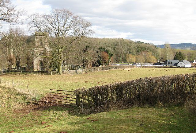 Pasture land, Dingestow With evidence of recent occupation by sheep. (It's still clinging to my boots). St. Dingat's Church sits North of the village. The buildings form part of the Bridge Farm holiday complex. Beyond is Mill Wood with its hidden motte. The yellowish trees are willows, close to the River Trothy. Note: Bridge Farm is named as Castle Farm on the map.