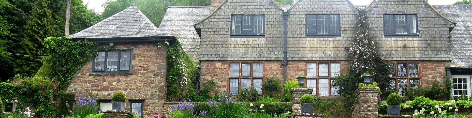Looking up at High Glanau Manor from the pond. High Glanau (also known as High Glanau Manor) is a country house and Grade II* listed building within the community of Cwmcarvan, Monmouthshire, Wales.