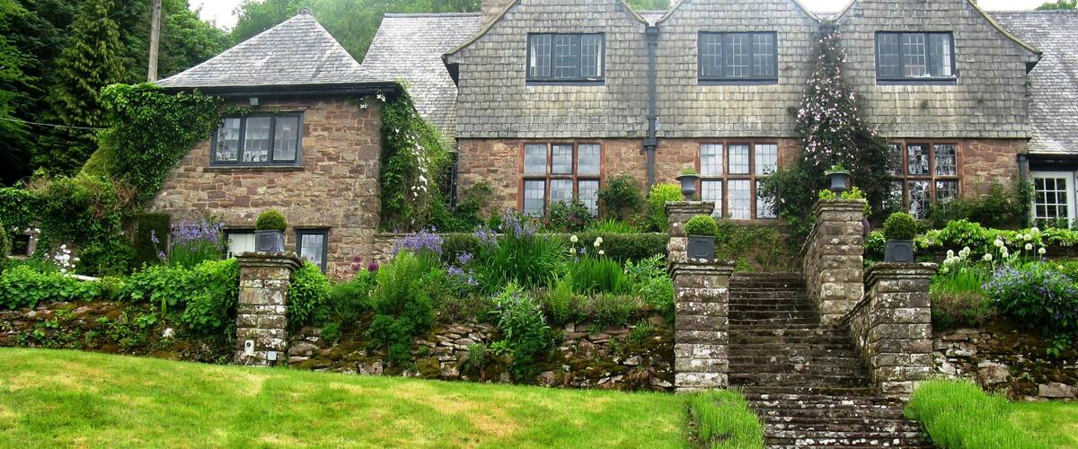 A stone house with a stone staircase leading to the entrance.