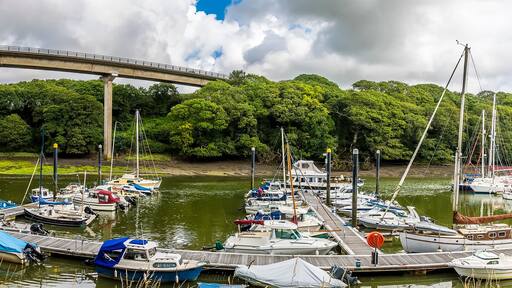 A panorama view of Westfield Pill showing boats moored and the road bridge at Neyland, Pembrokeshire, South Wales on a summers day