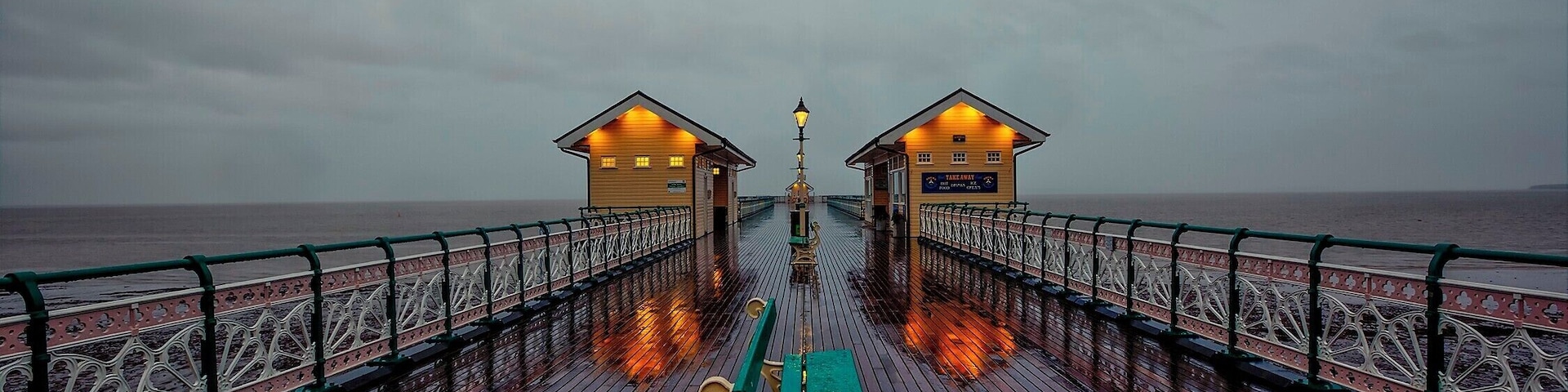 Taken on a wet afternoon just as the lights had been turned on to show the reflections in the wet pier