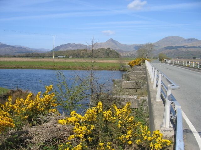 Pont Croesor over the Afon Glaslyn. Looking across the soon to be re-instated Welsh Highland Railway bridge on a sunny spring day with Cnicht in the distance. Compare with 2108 in less clement weather.