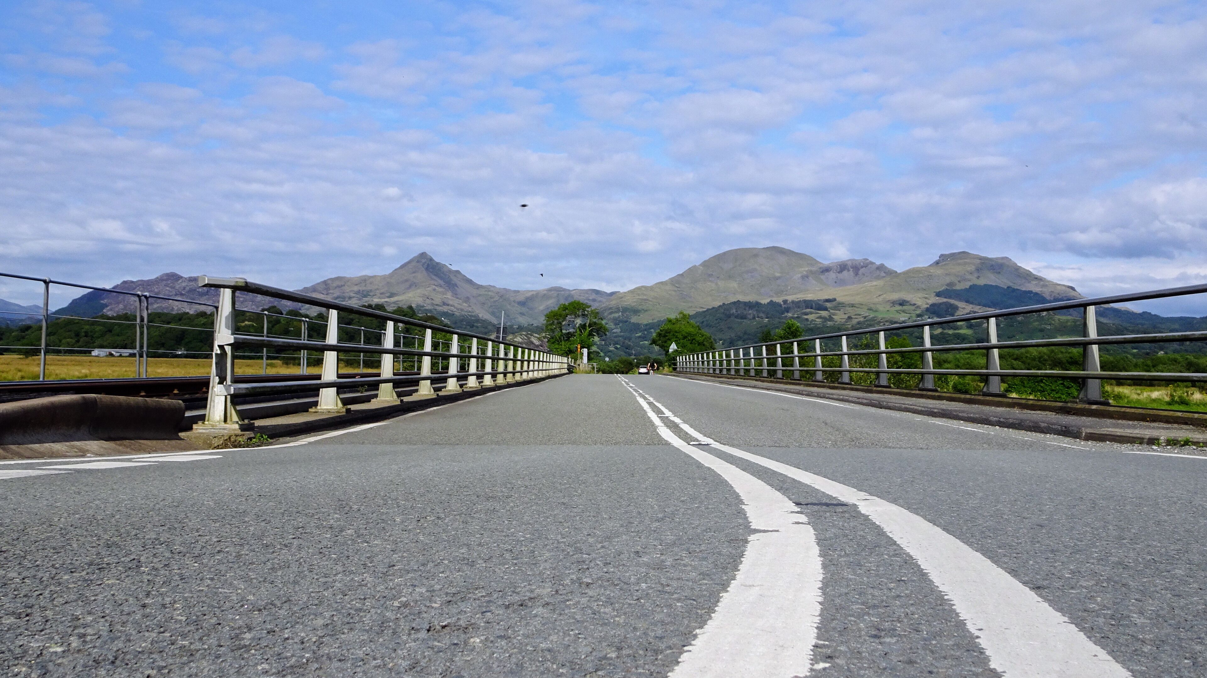 A bridge with mountains in the background.