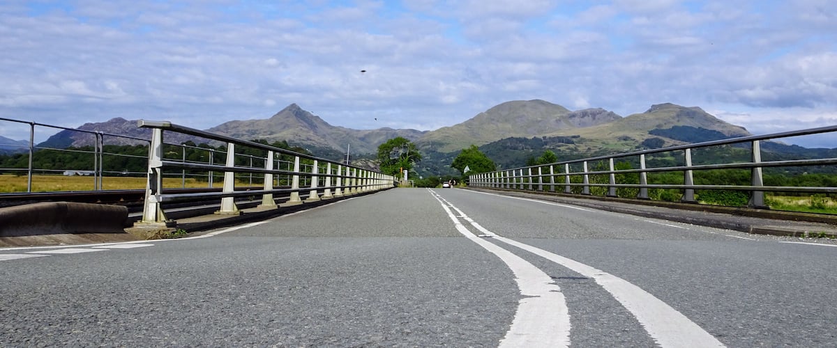 A bridge with mountains in the background.