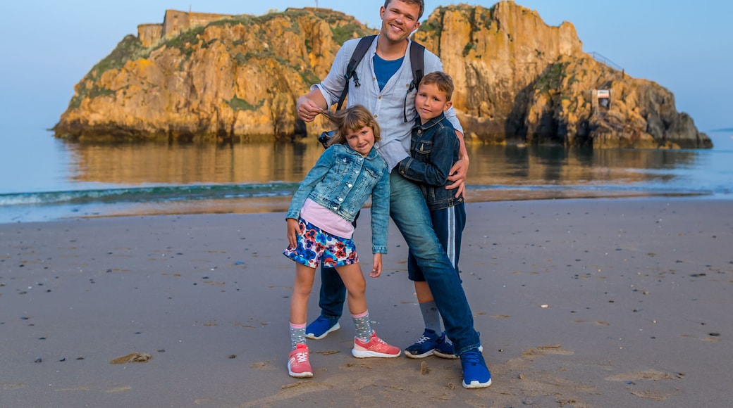 Family at the seaside after sunset, Wales