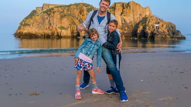 Family at the seaside after sunset, Wales
