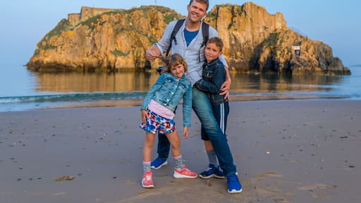 Family at the seaside after sunset, Wales