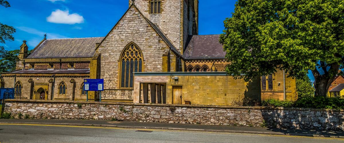 A historic church with a tall tower and arched windows.